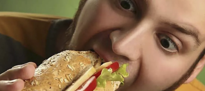 Adolescente comiendo hamburguesa